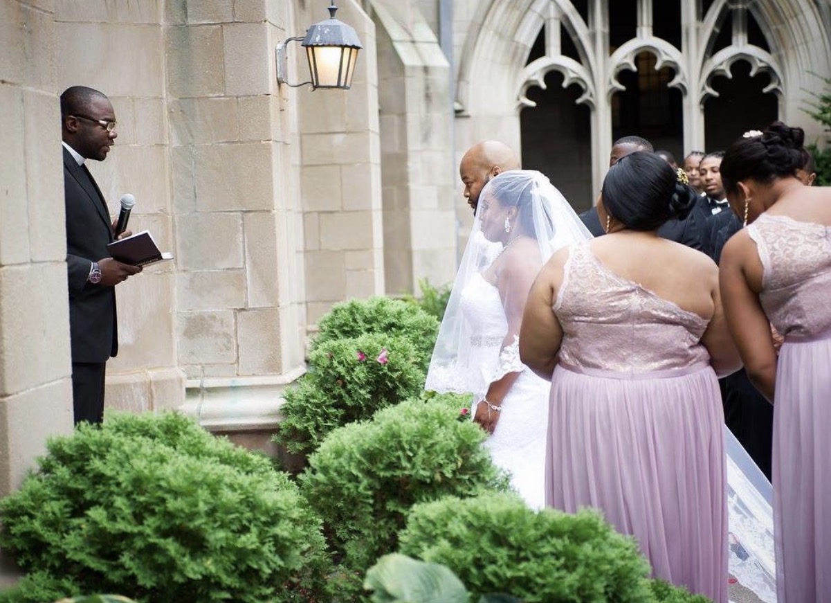 The wedding ceremony with the bridal party looking on