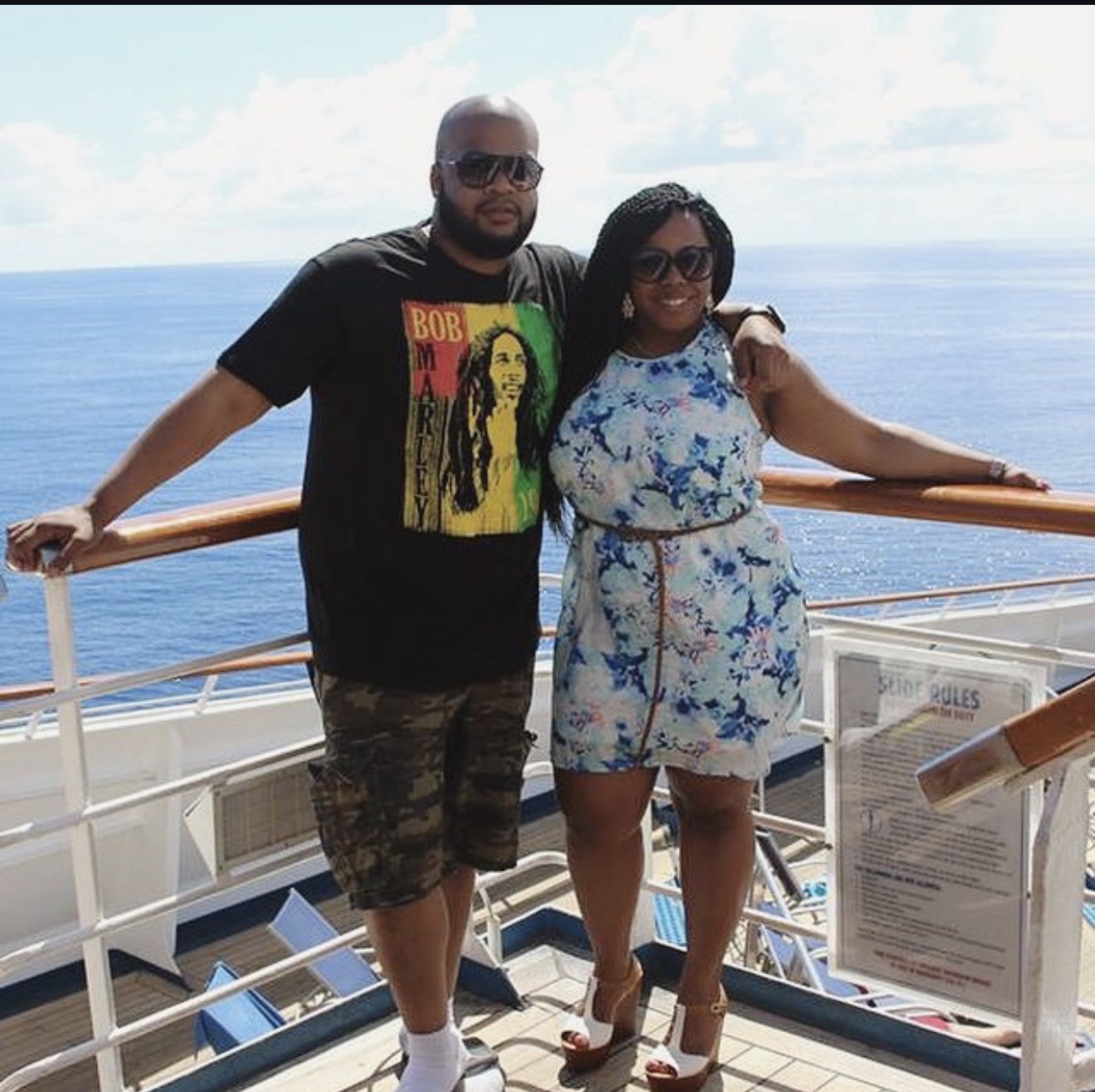 Ta'Keisha and Sixto on a cruise ship deck with the open ocean behind them